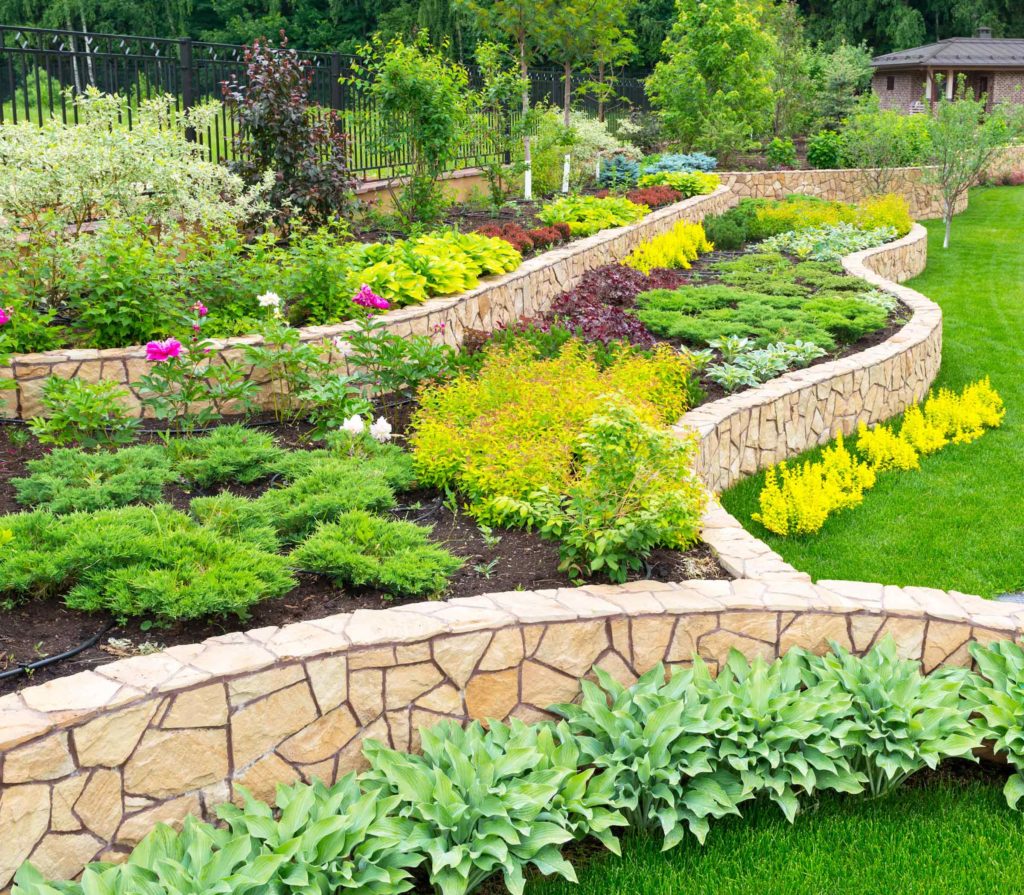 landscaped planter beds along stacked retaining walls