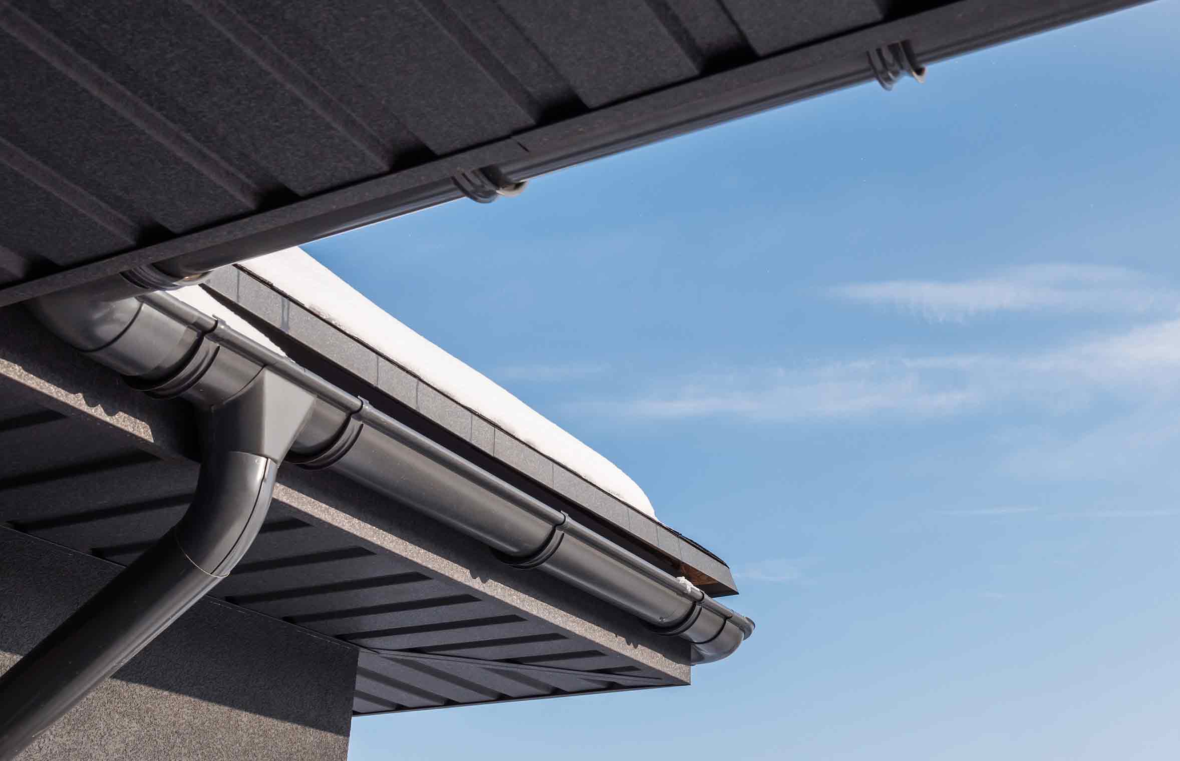 professionally installed rain gutters with downspouts